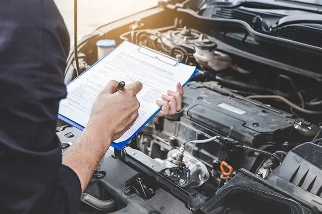 A Mechanic is Working on the Engine of a Car in a Garage — Mechanical World In Wagga Wagga, NSW