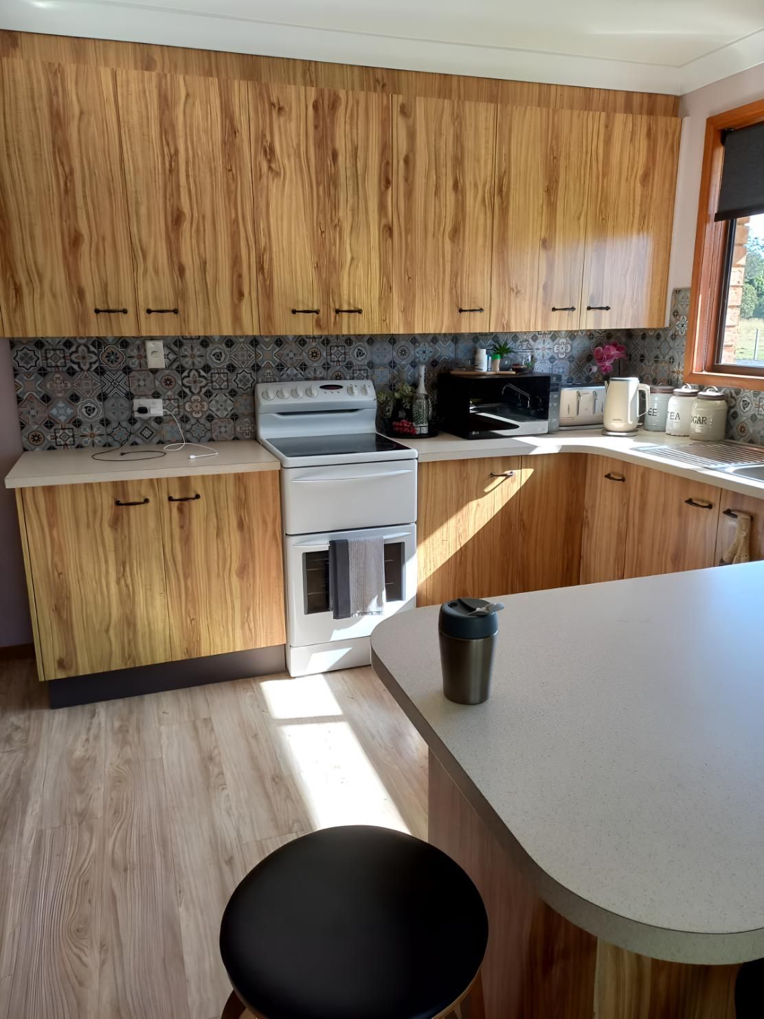 A Kitchen With Wooden Cabinets and a White Stove — BM Cabinetry In Spring Grove, NSW