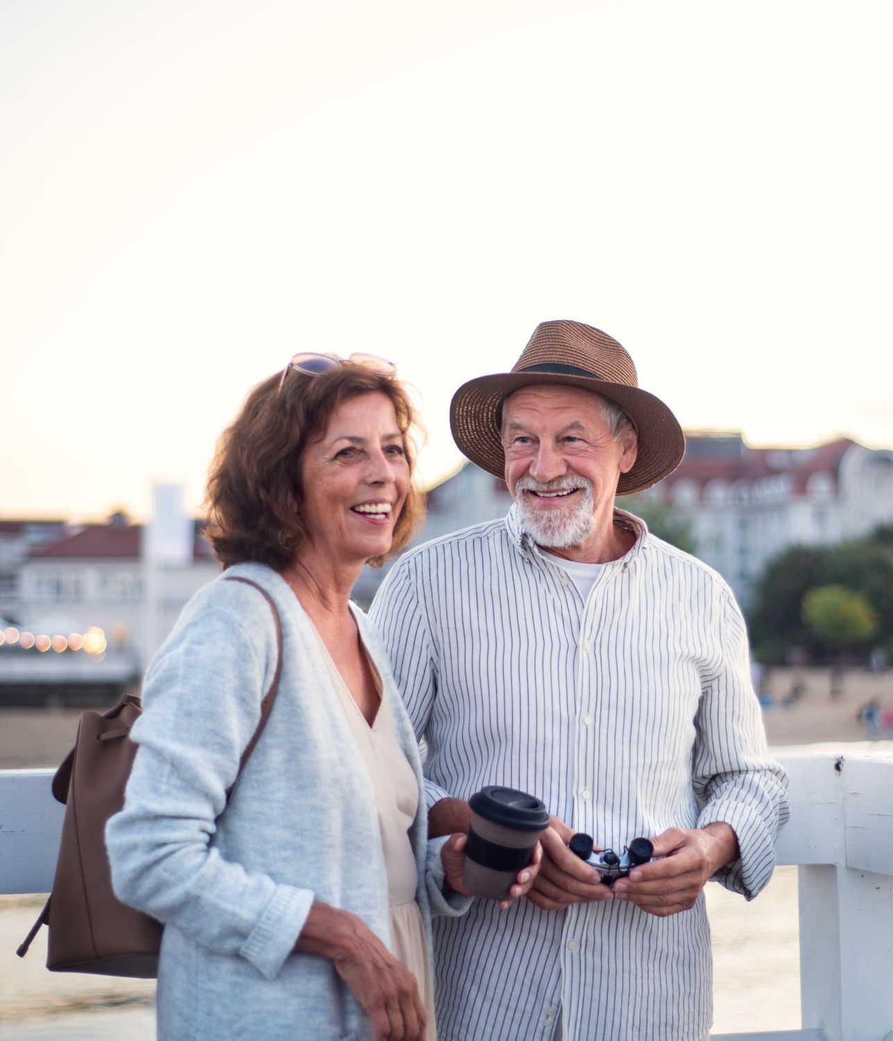 A man and a woman are standing next to each other on a bridge.