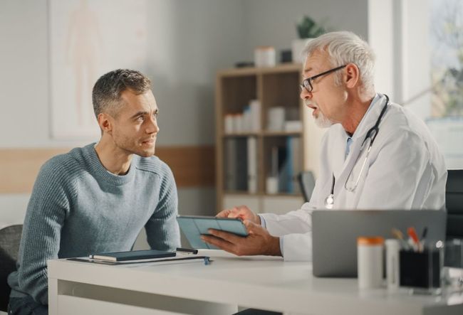 A Doctor is Talking to a Patient while Holding a Tablet — Little Rock, AR — Benny J Green MD PA A Doctor is Talking to a Patient while Holding a Tablet — Little Rock, AR — Benny J Green MD PA