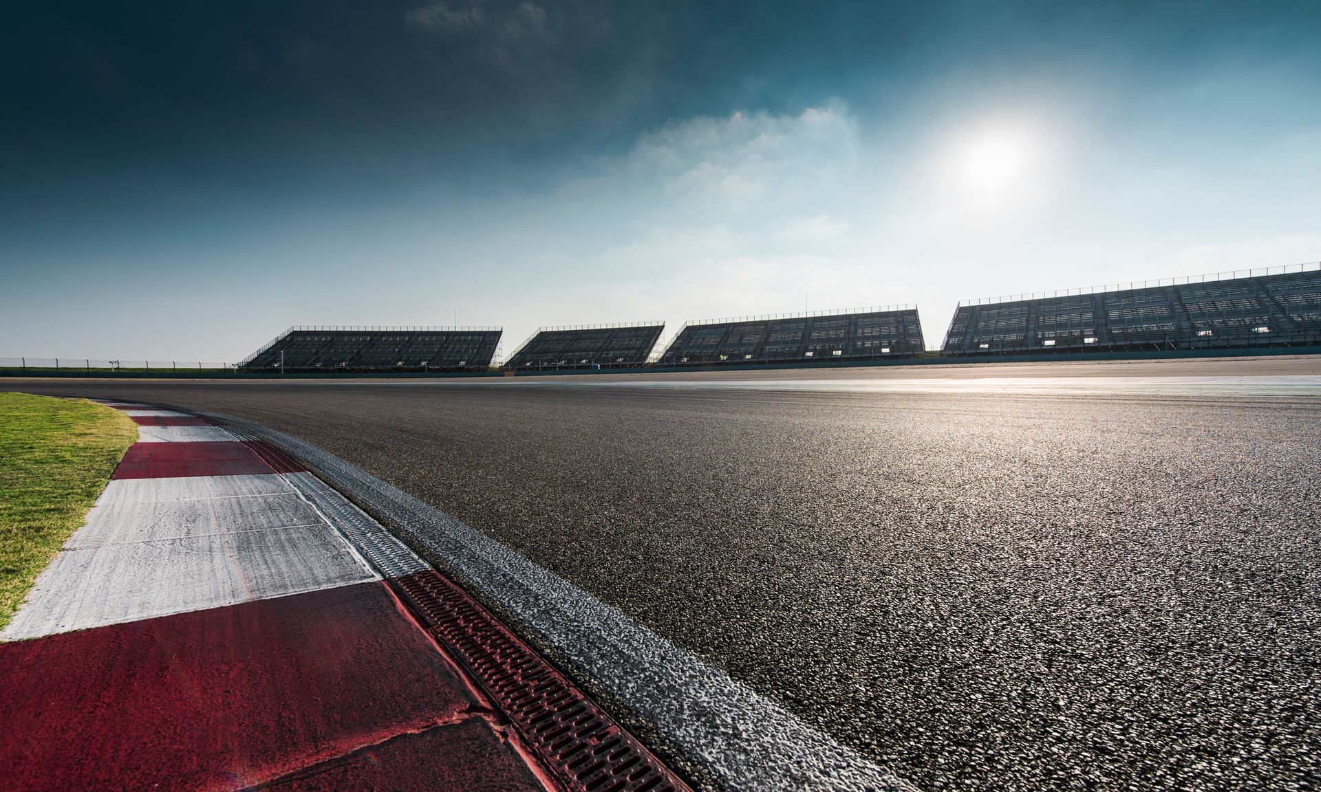 Two people are riding go karts on a track.