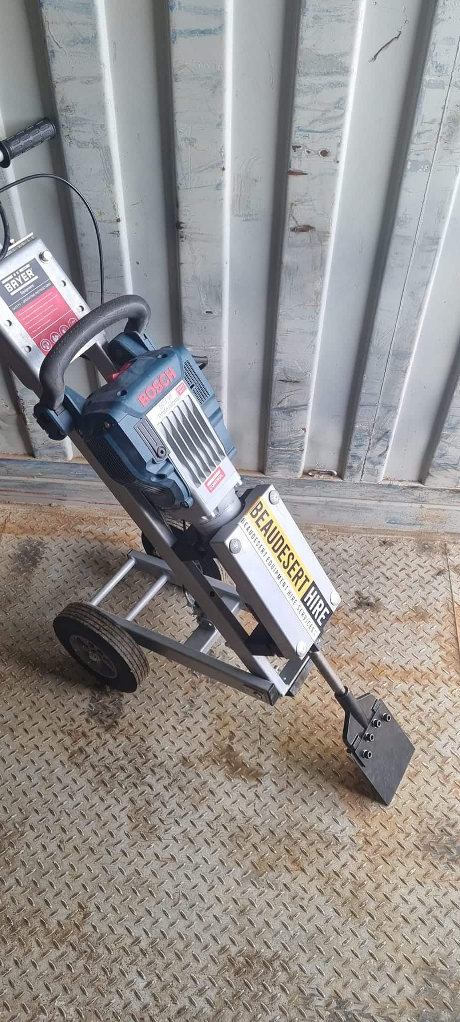A drill is sitting on a cart in front of a wall. — Beaudesert Equipment Hire Services in Beaudesert, QLD