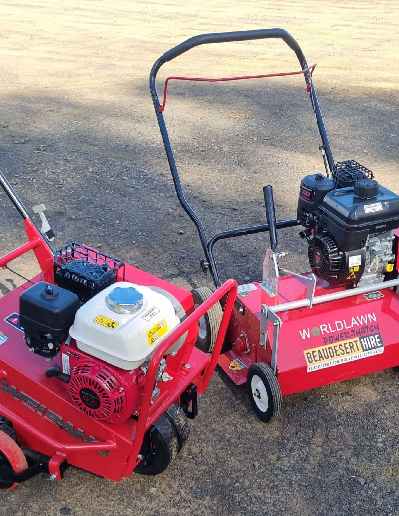 Two red lawn mowers are parked next to each other on the ground. — Beaudesert Equipment Hire Services in Beaudesert, QLD
