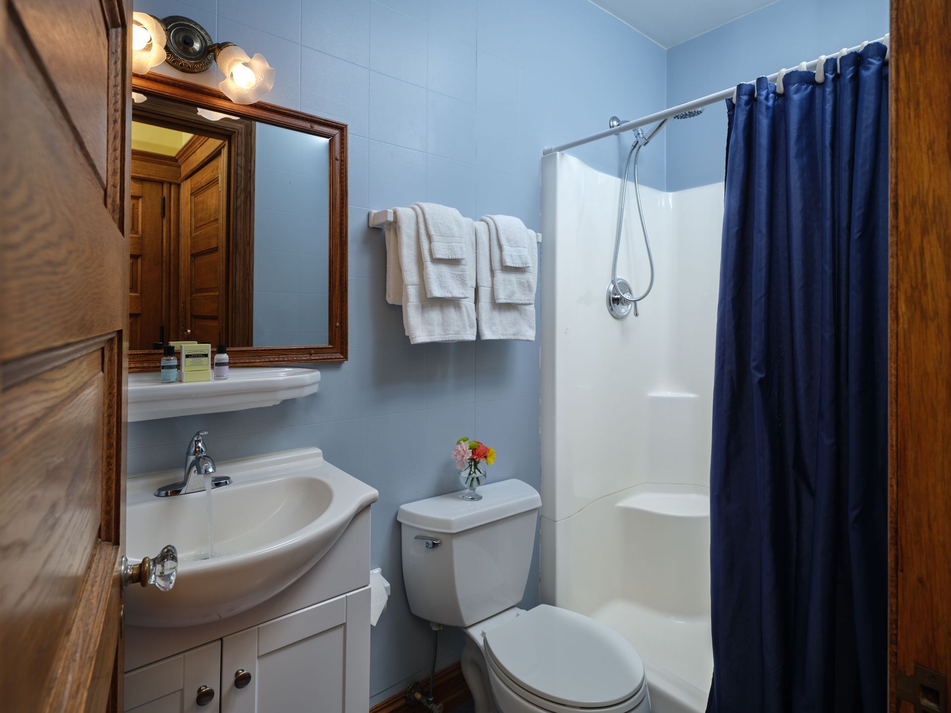 A bathroom with a toilet , sink , and shower.