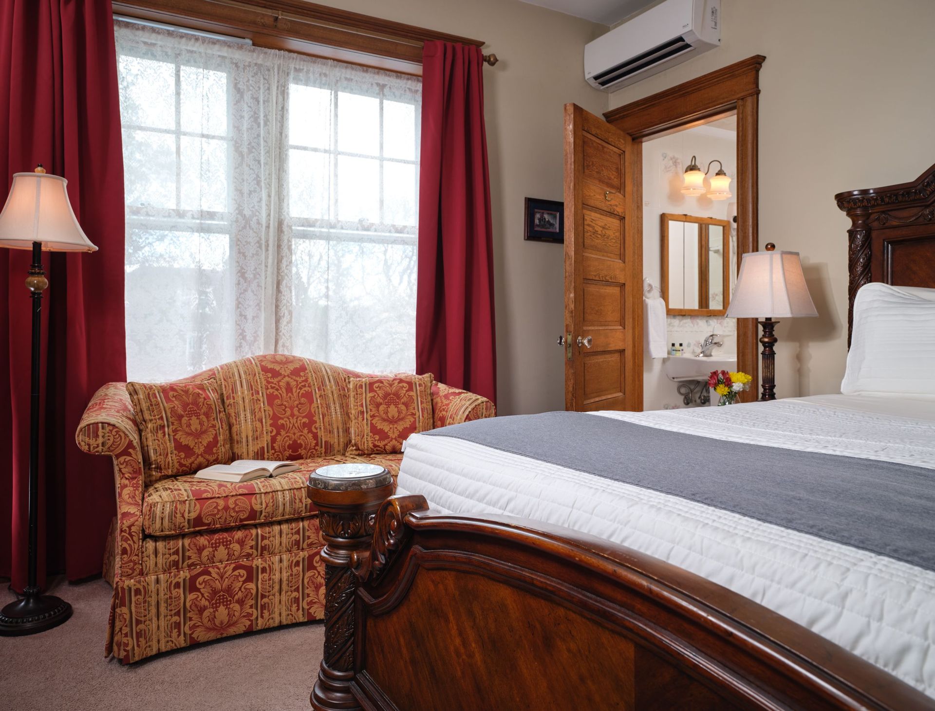 A bedroom with a bed and a couch in it
