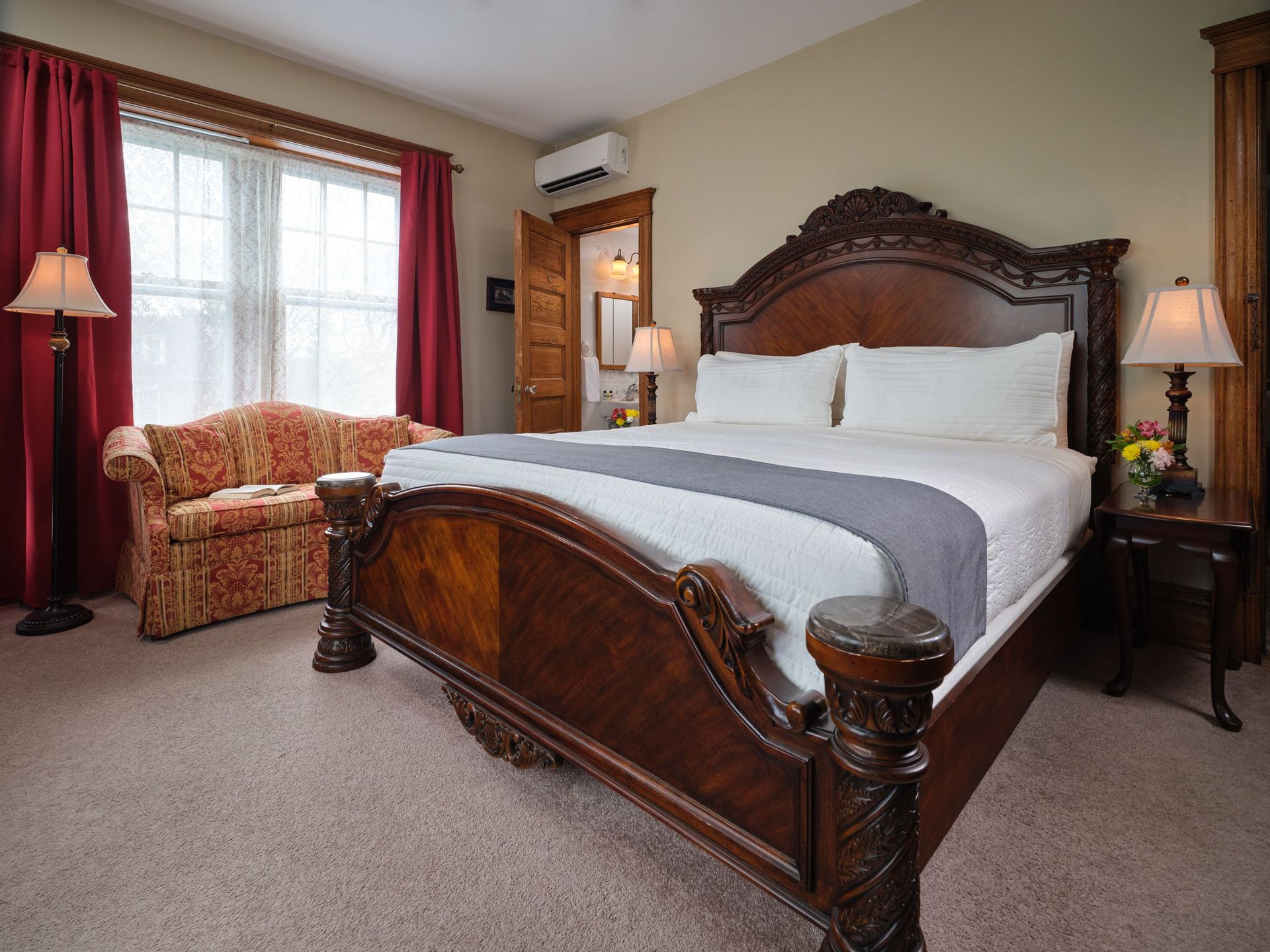 A bedroom with a king size bed and a couch