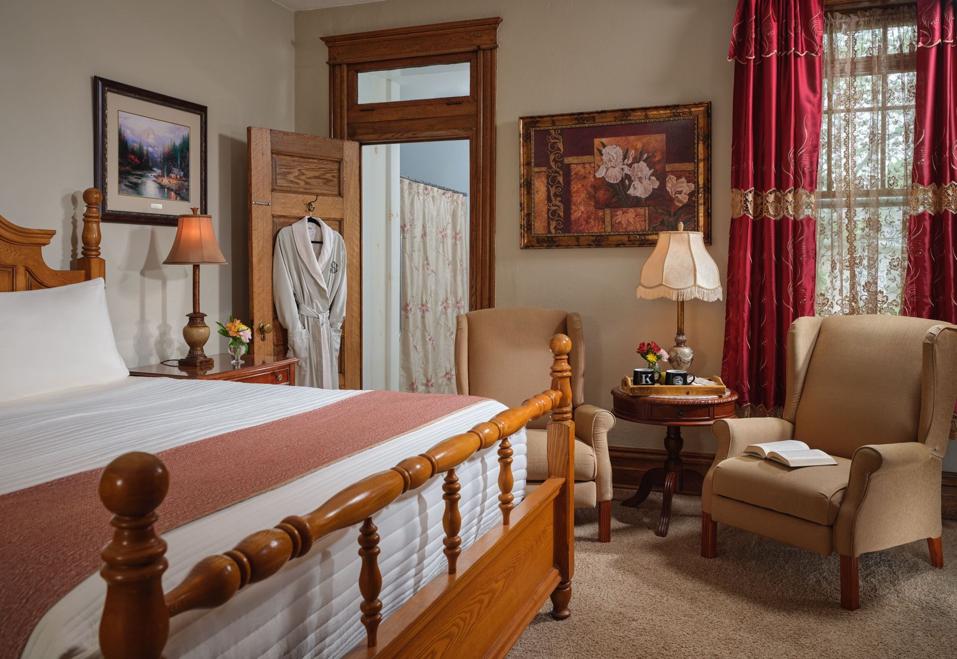 A bedroom with a bed , chair , table and lamps
