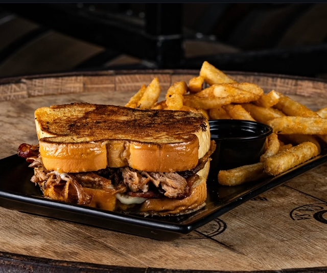 pulled pork, ham, bacon, & American cheese sandwiched between 2 pieces of thyme batter Texas toast, light aioli with a side of triple berry jam for
dipping and a side of French fries