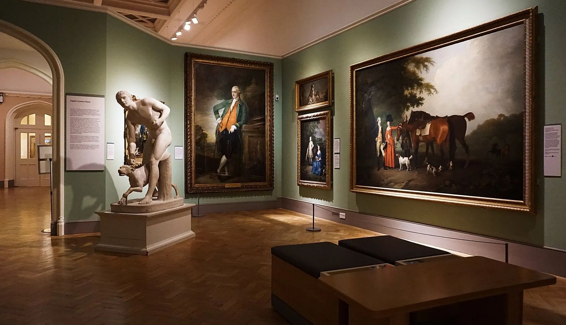 A museum with a statue and paintings on the wall