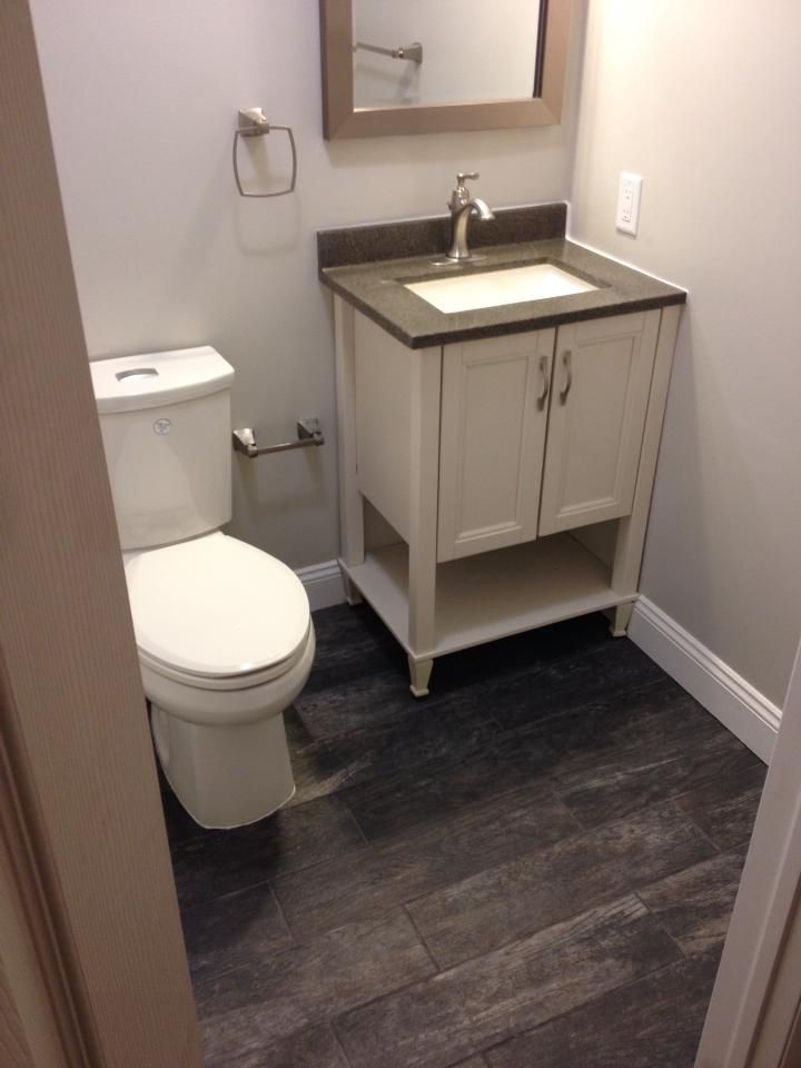A bathroom with a toilet a sink and a mirror