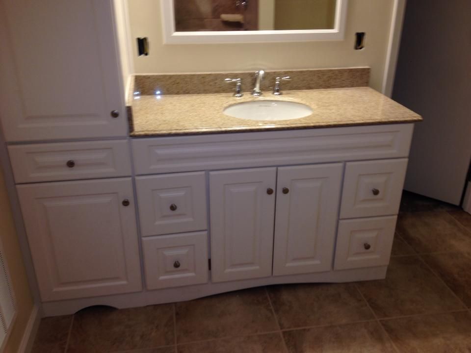 A bathroom vanity with a sink and a mirror