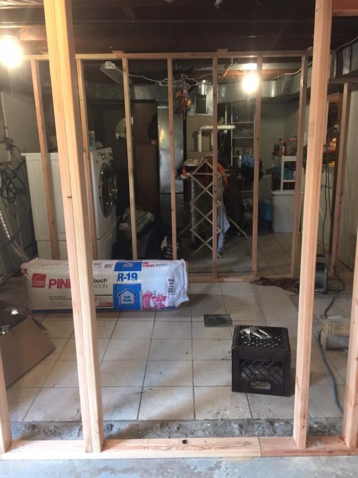 A room with a lot of wooden frames and a crate on the floor.