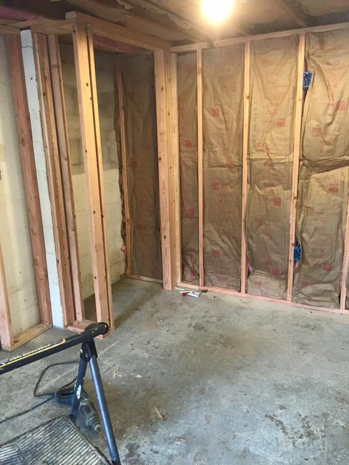 A room with a lot of wooden frames and insulation on the walls.