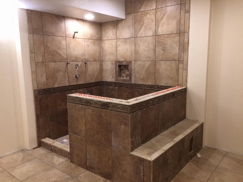 A bathroom with a large tub and a shower.