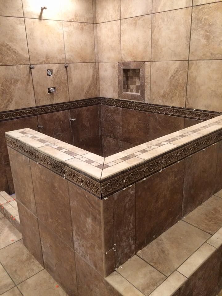 There is a large bathtub in the middle of the bathroom.