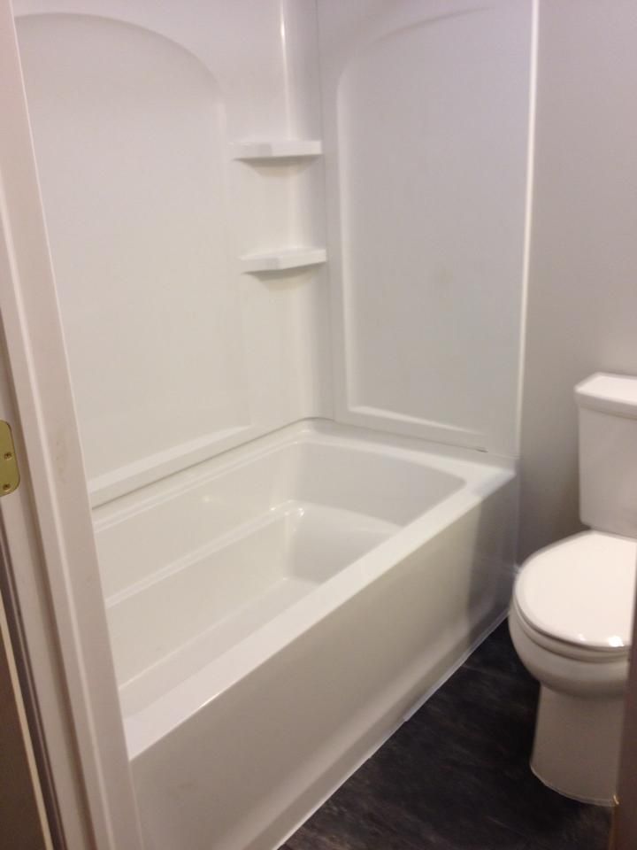 A bathroom with a bathtub and a toilet.