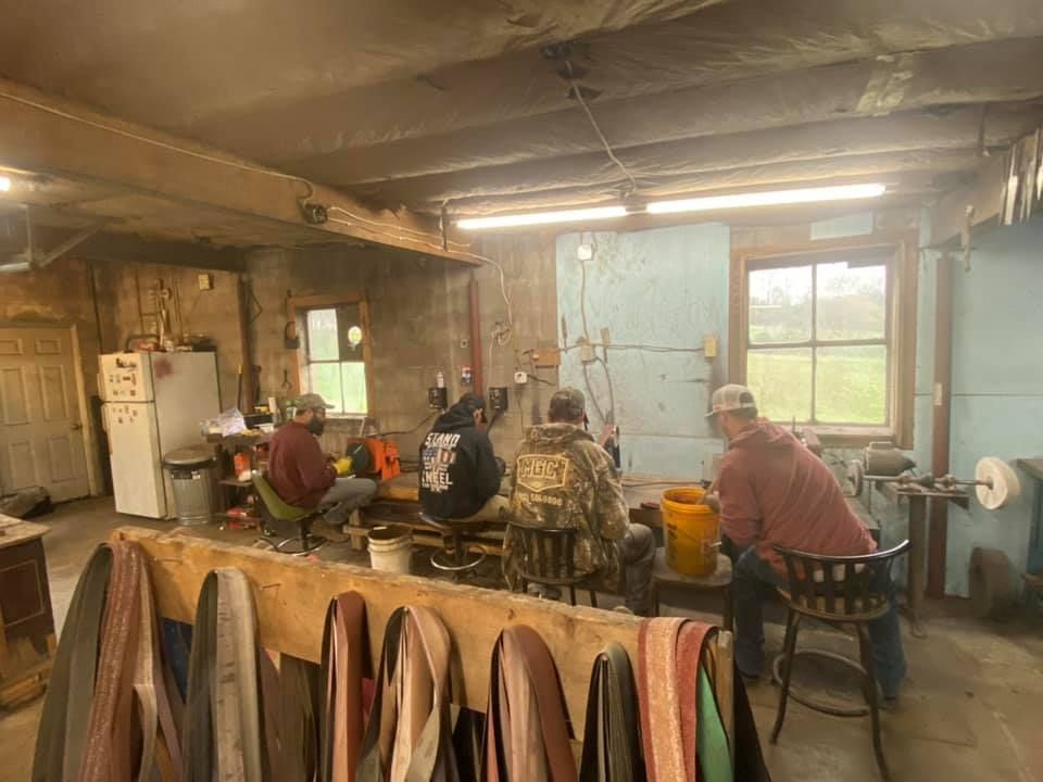 A group of men are working in a workshop.