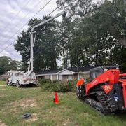 A red and white utility truck is parked in a grassy field. A red and white utility truck is parked in a grassy field.