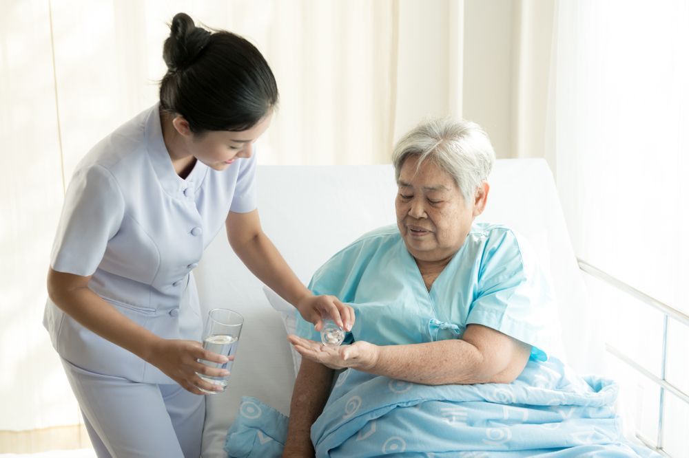 Nurse Assisting a Patient in Bed — Ani's Care Pty Ltd In Millner, NT