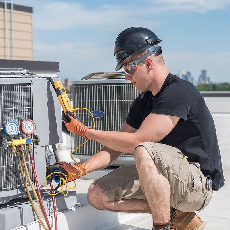 Man Checking The Air Conditioner