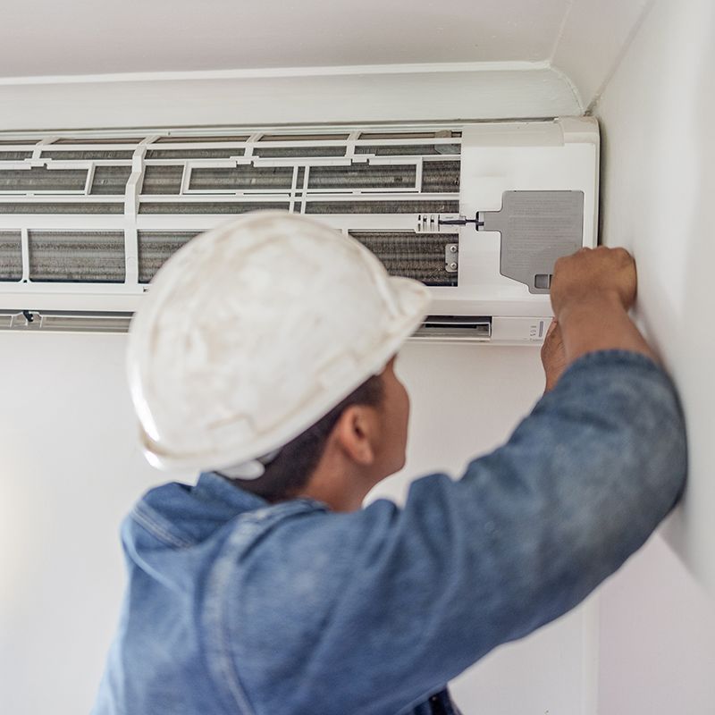 Worker Checking The Air Conditioner Worker Checking The Air Conditioner