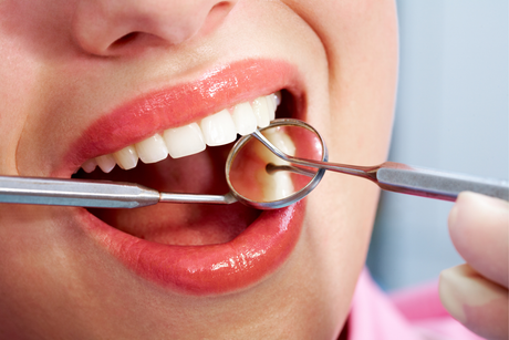 Close-up of a smiling mouth with white teeth and pink lips