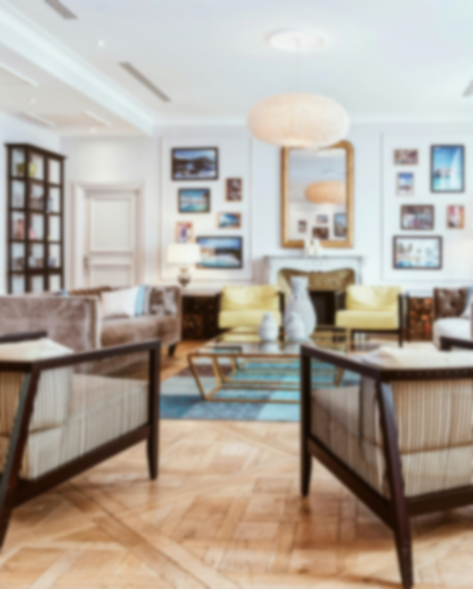 Bright living room with stylish seating, wood floors, and modern decor accents.
