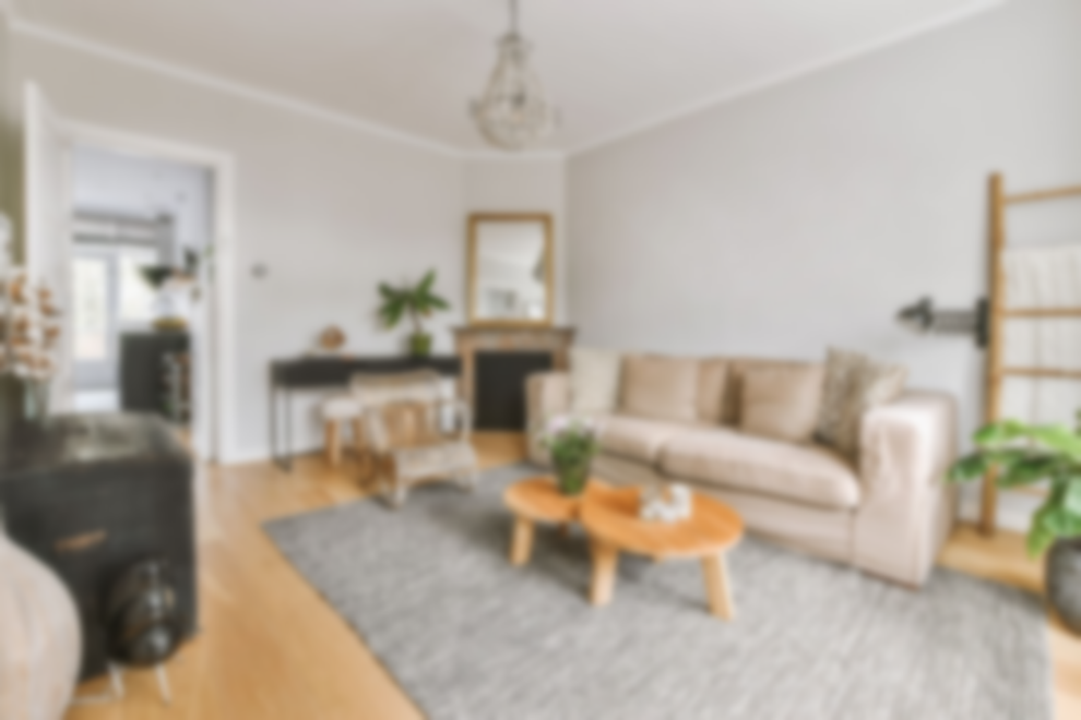 Bright living room with neutral decor, hardwood floors, and a comfortable seating area.