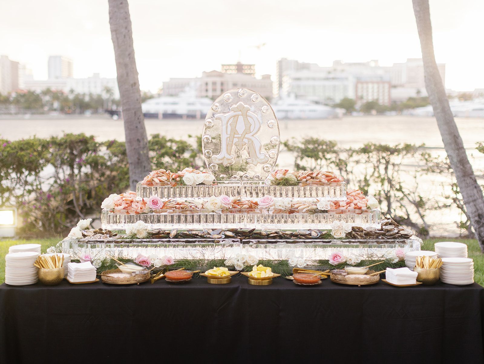 A buffet table with a large ice sculpture on top of it.