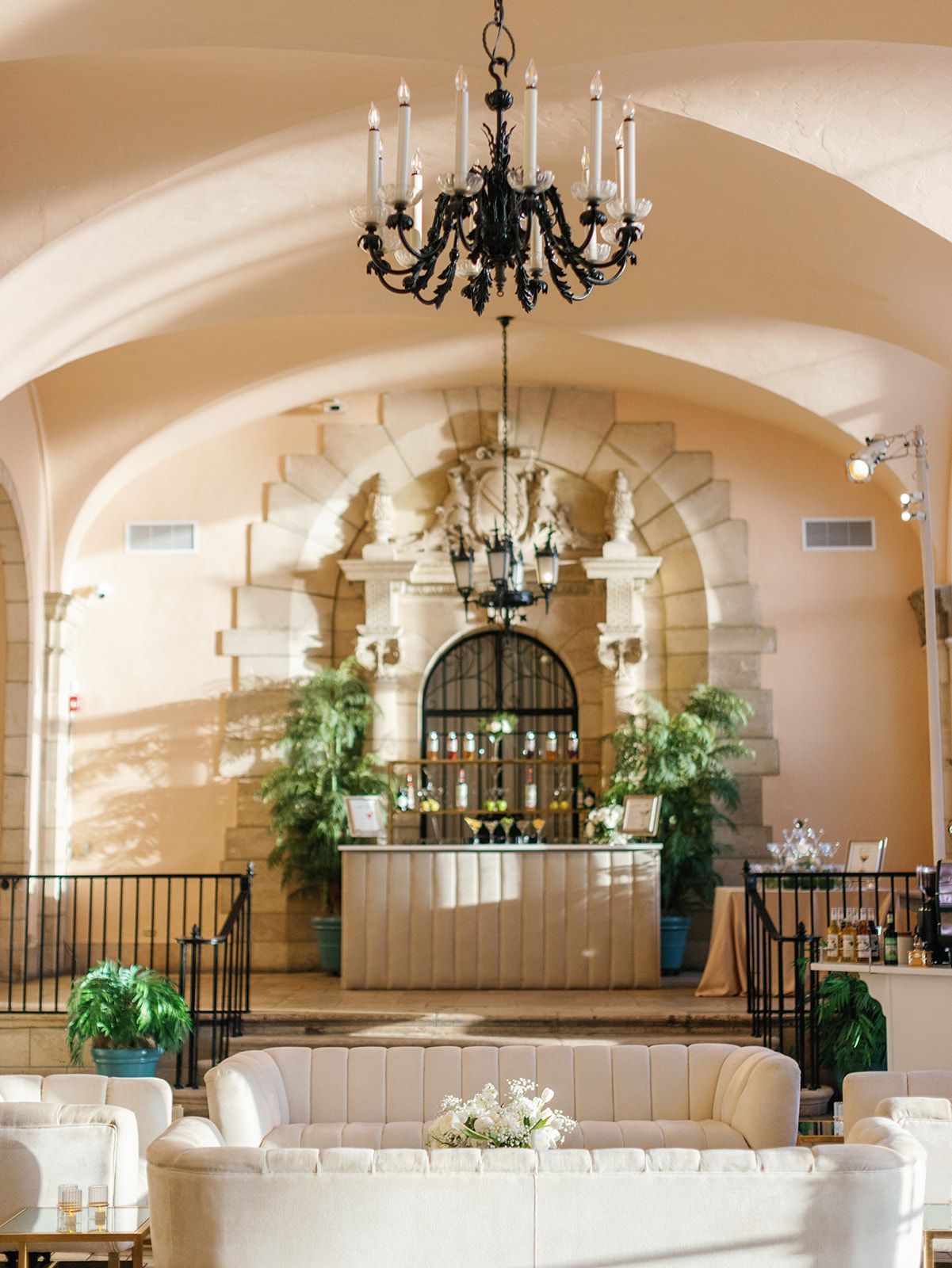 A large room with a couch and a chandelier hanging from the ceiling