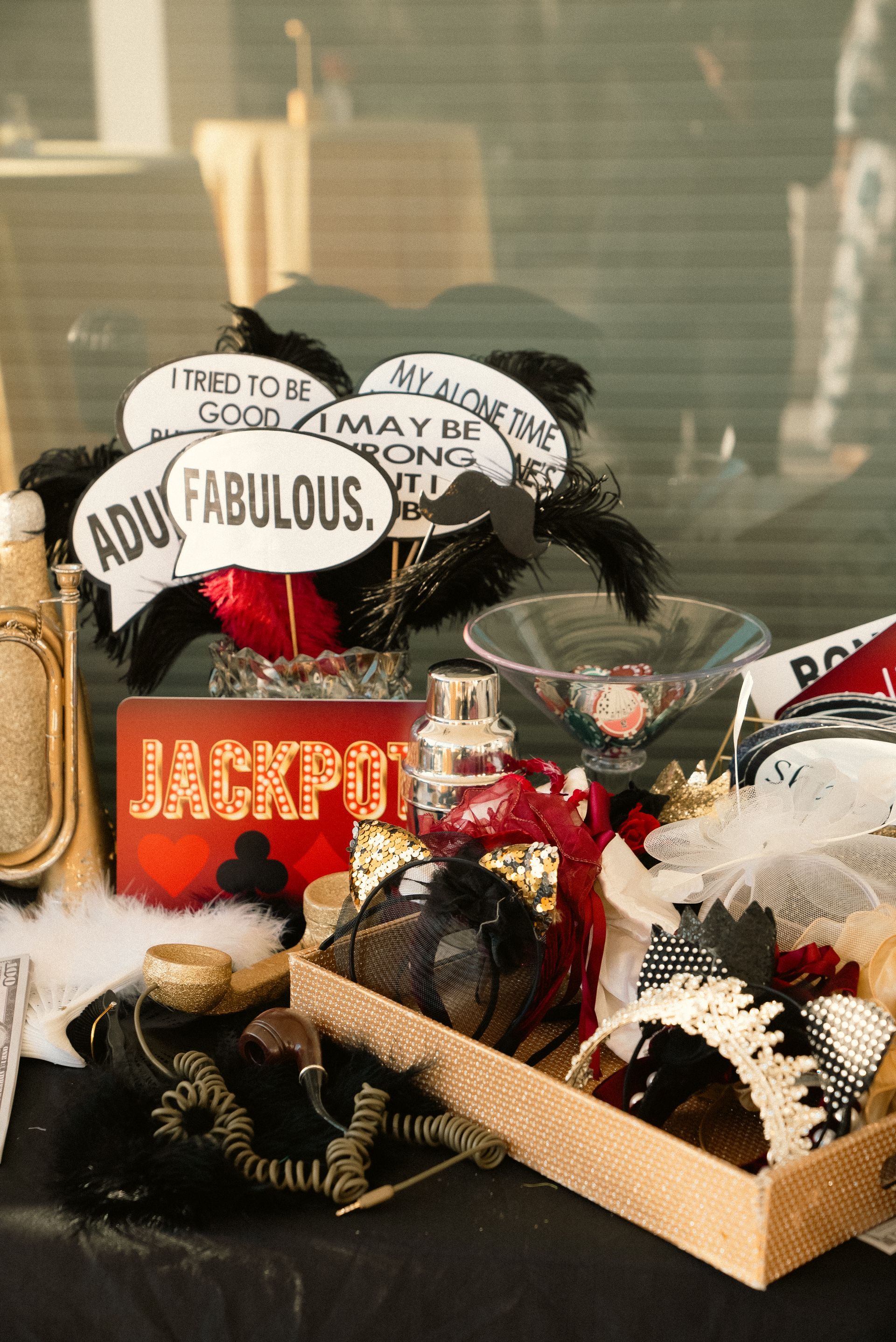 Gift basket with “Jackpot” sign, stuffed ribbons, and small decorative items in a wicker tray
