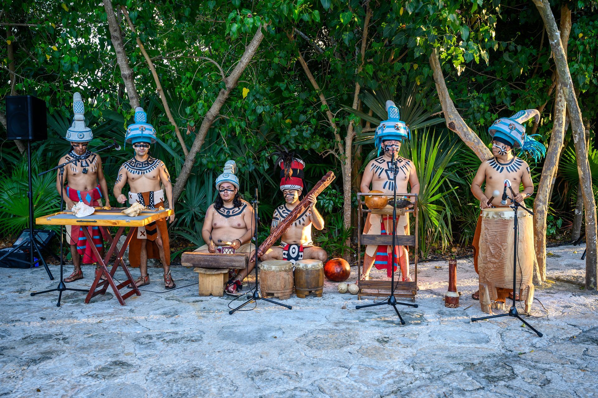 A group of men are playing instruments on a beach.
