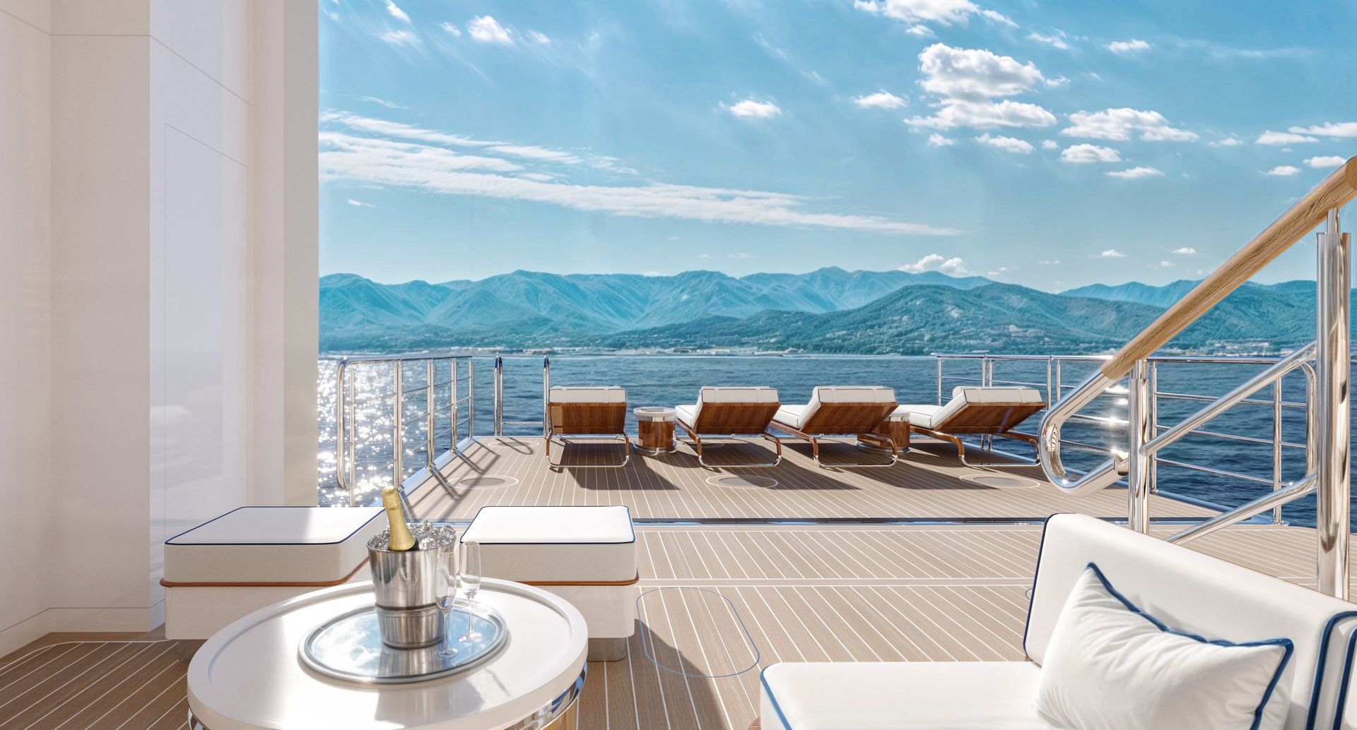 Luxury balcony with lounge chairs, white table, and mountain view beyond glass railing