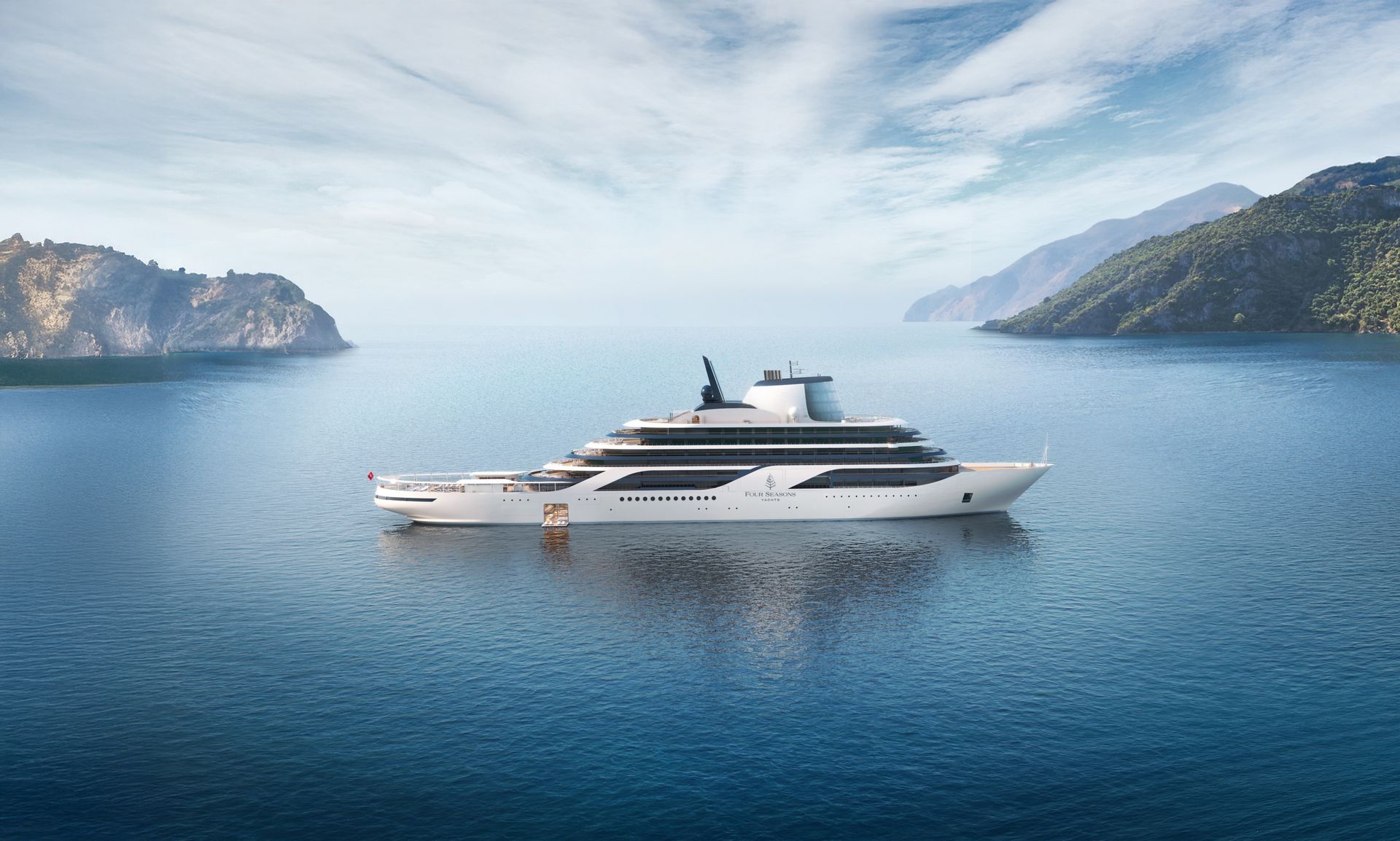 White luxury yacht on calm blue water between rocky green coastlines under a bright sky