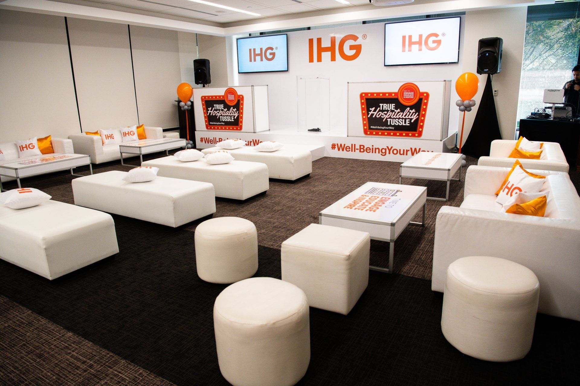 A room with a lot of furniture and a sign that says ihg