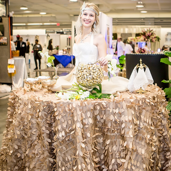 A woman in a wedding dress is standing in front of a table