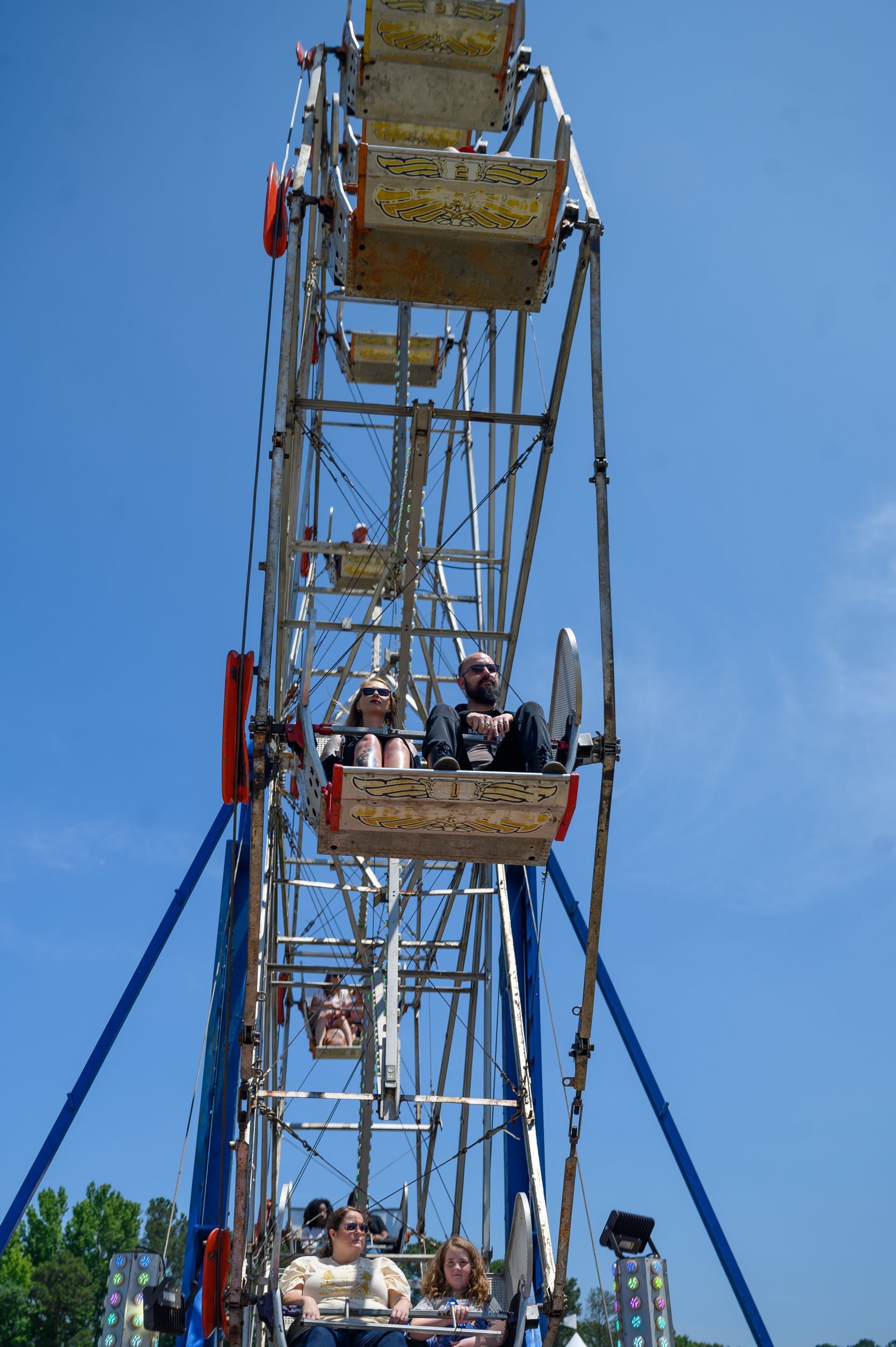 People are riding a ferris wheel with a sign that says ' ferris wheel ' on it