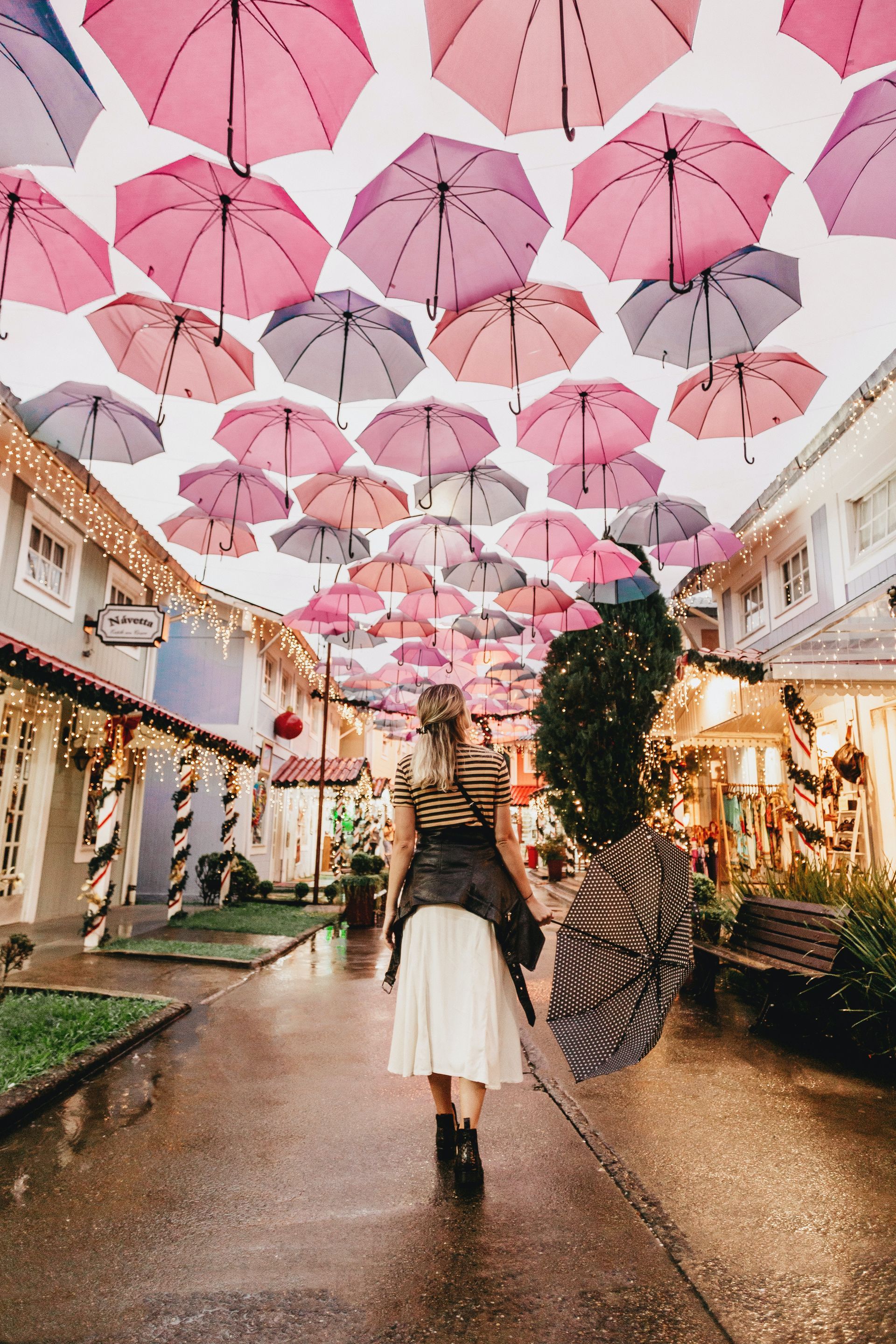 Woman standing in front of Umbrella Sky Project