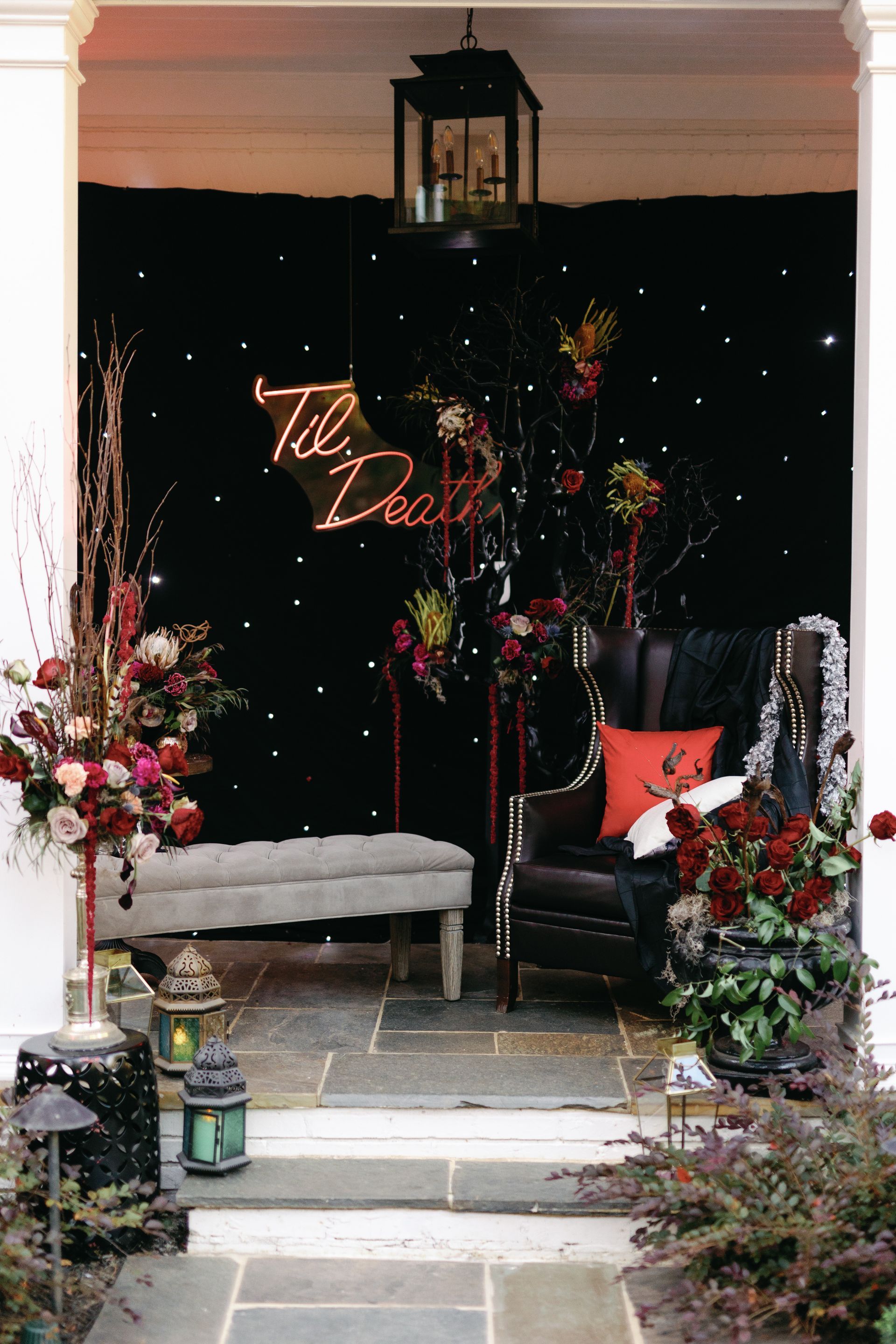 A porch decorated for a party with a chair and bench