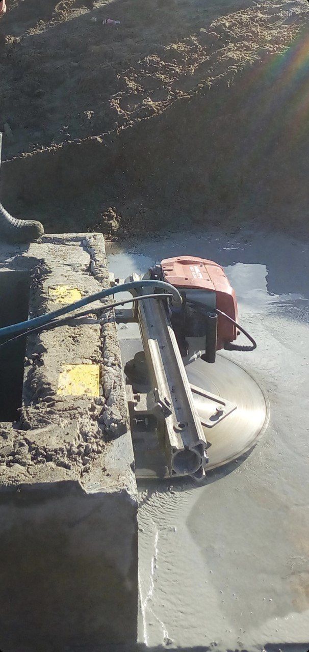 A Machine Is Cutting a Concrete Wall with A Circular Saw — Hyper Cut & Drill in Swansea, NSW