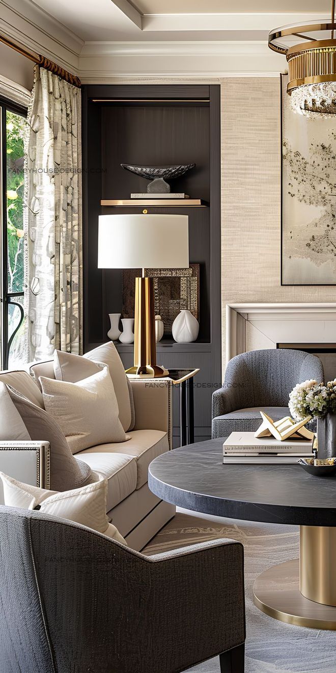 Living room with sofa, chairs, round table, lamp, and artwork. Neutral colors with gold accents.