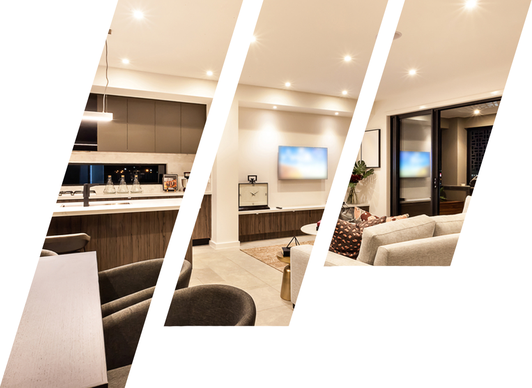 A living room with a couch and a television on the wall.