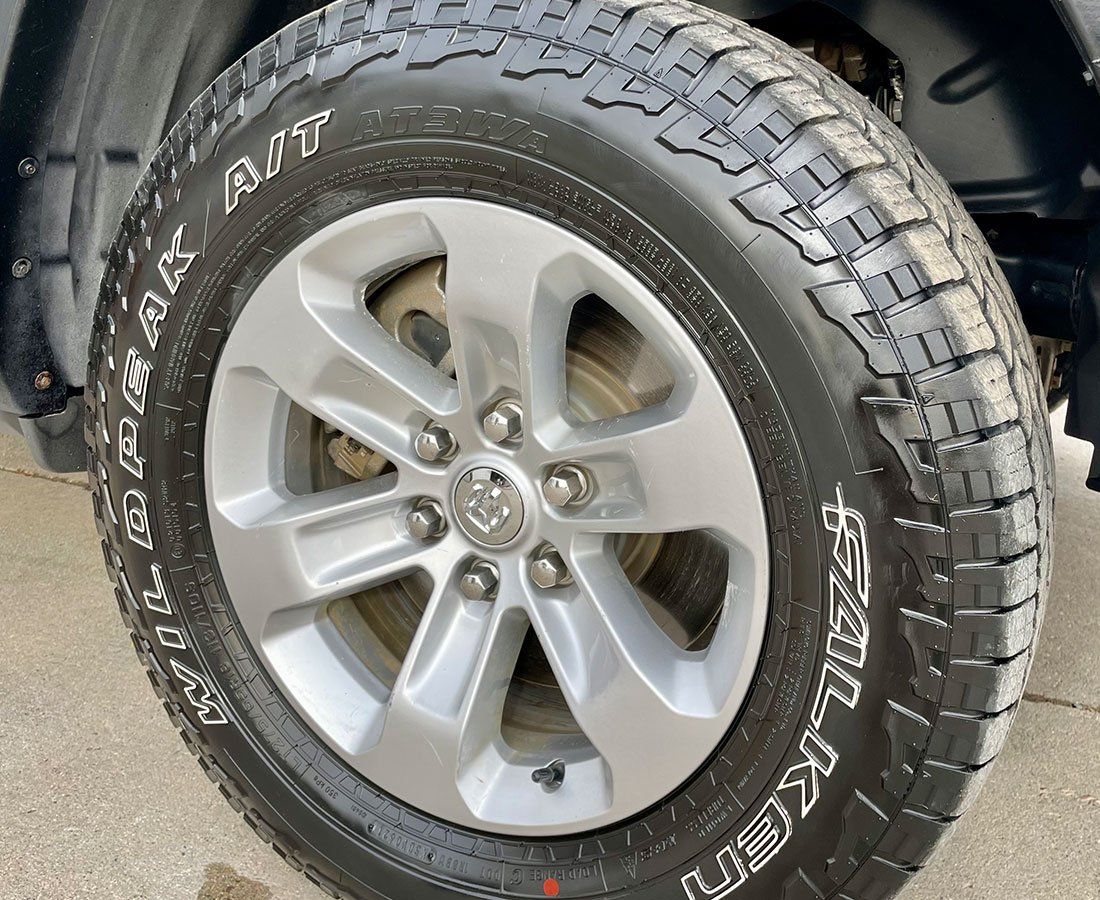 A close up of a tire on a car wheel.
