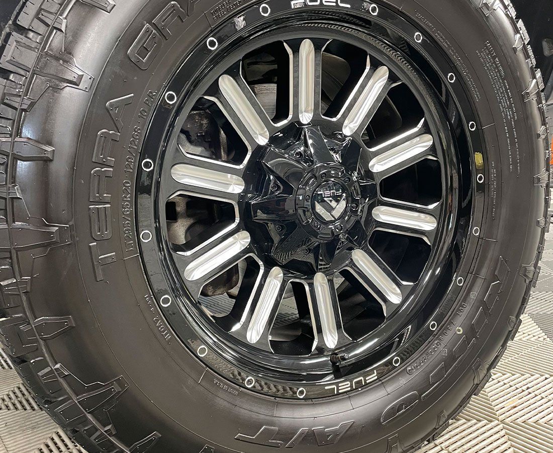A close up of a tire and wheel on a car.
