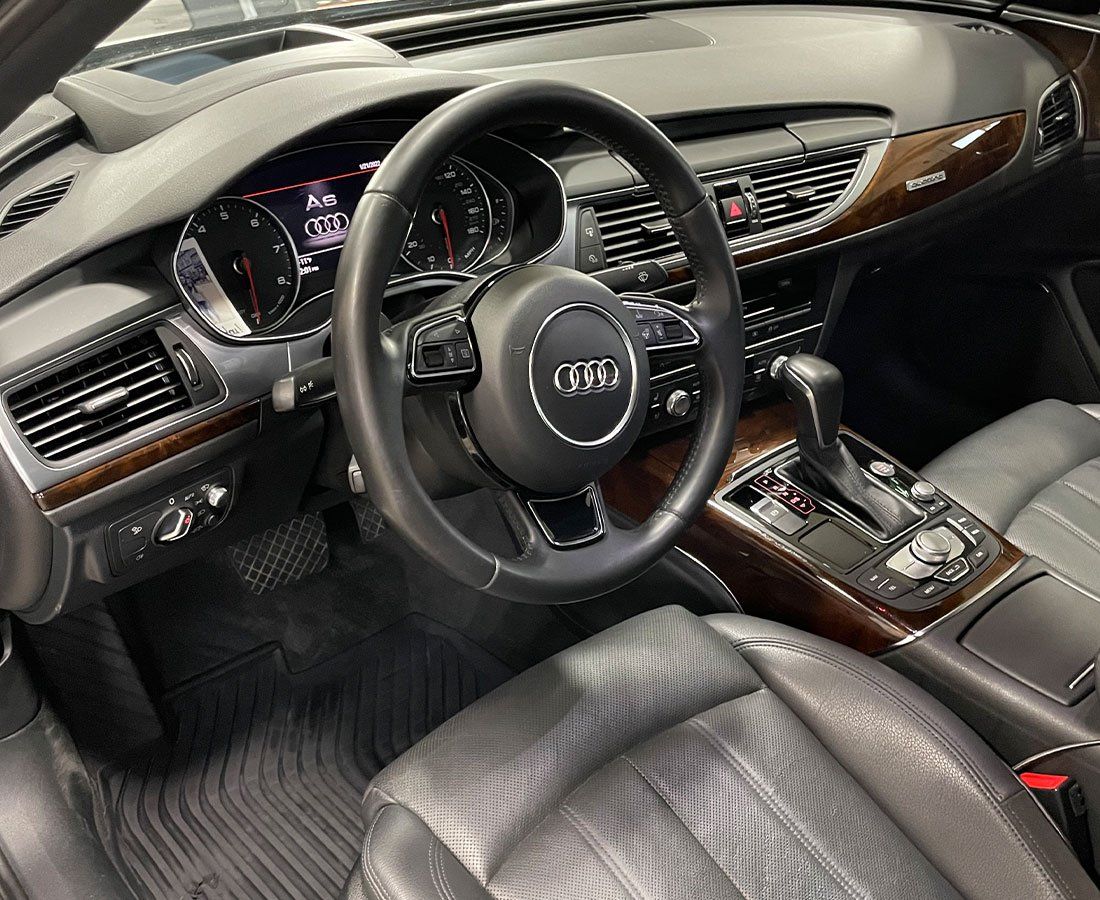 The interior of a car with a steering wheel and dashboard.