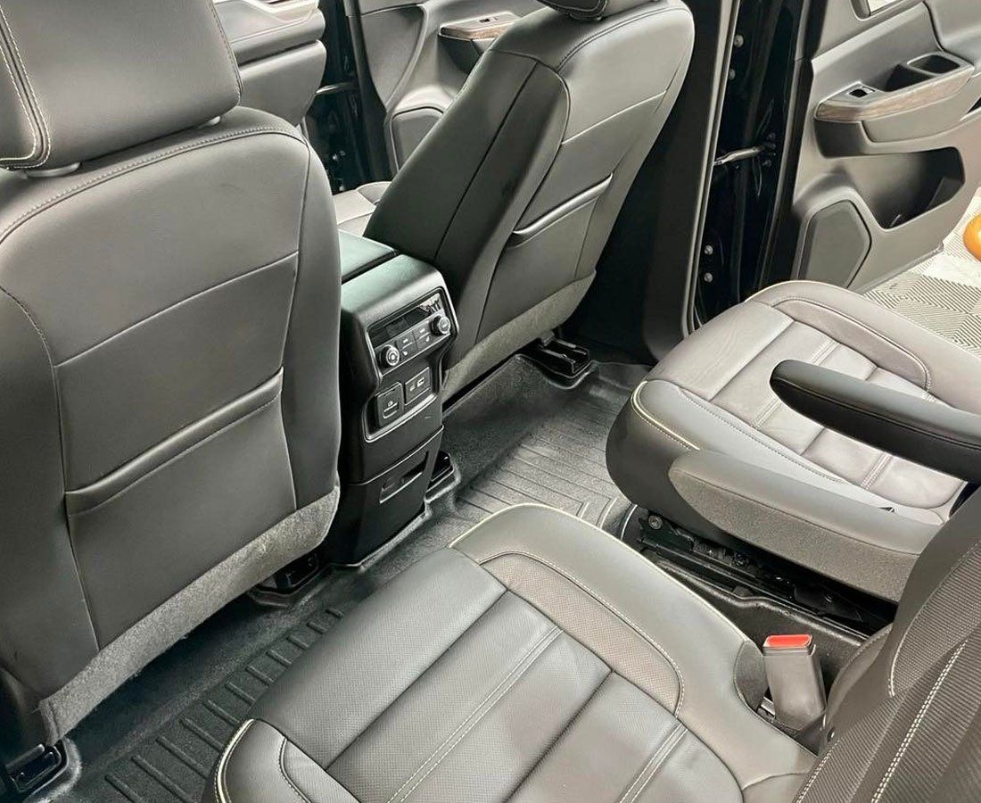 The interior of a car with leather seats and a center console.
