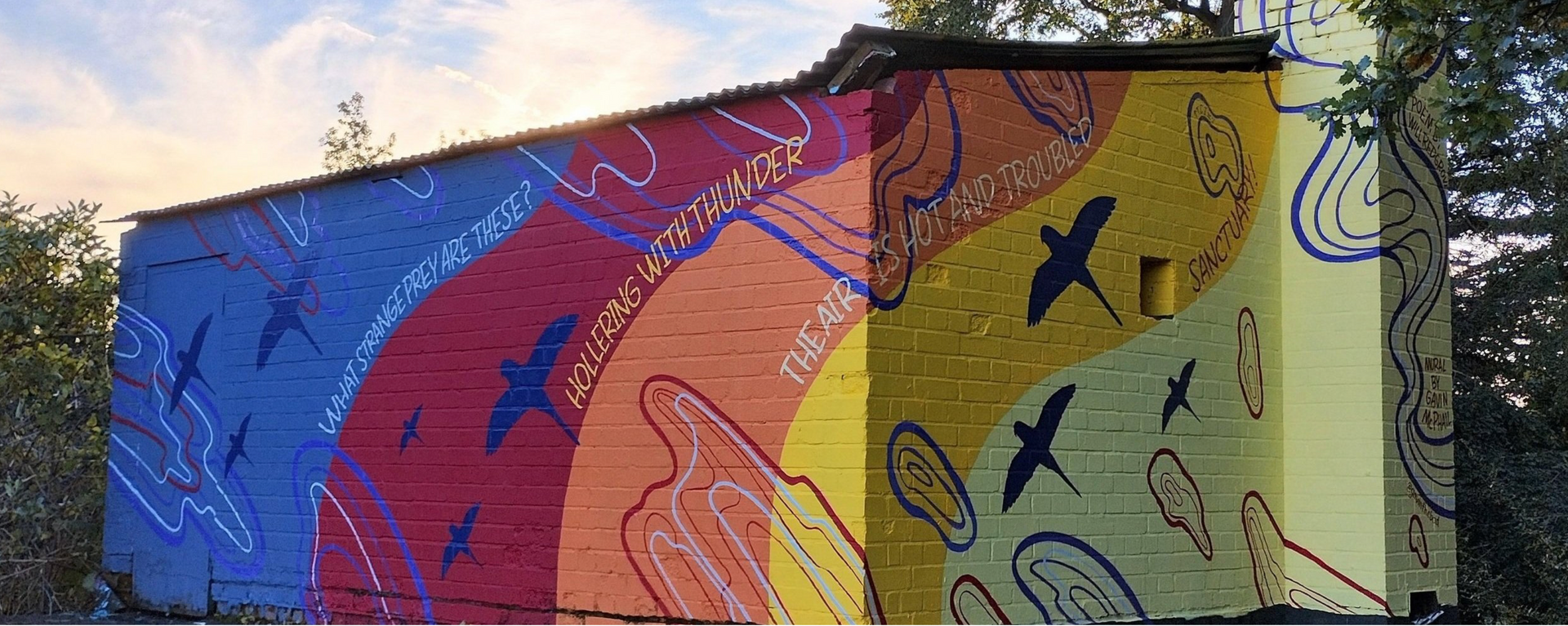 A colorful mural on the side of a building.
