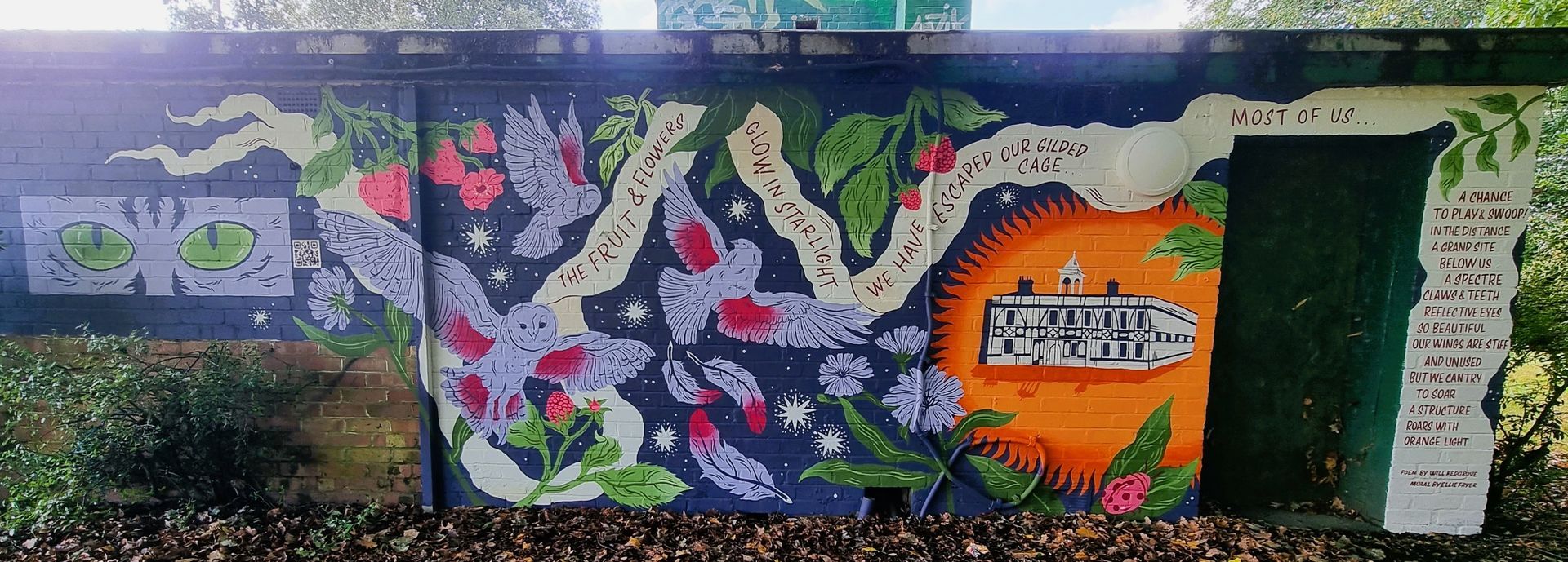 A mural on the side of a building with flowers and leaves on it.