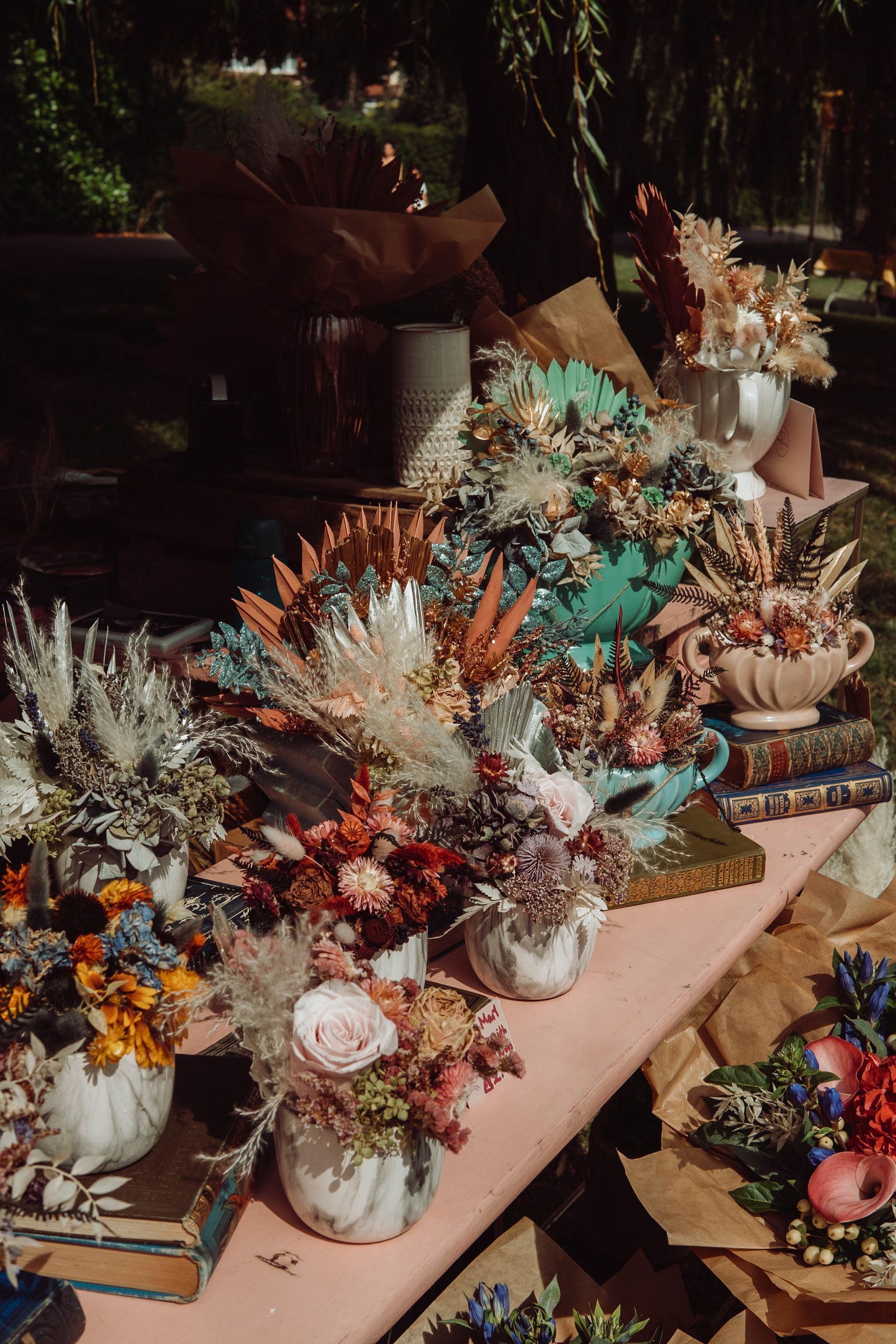 There are many different types of flowers on the table.
