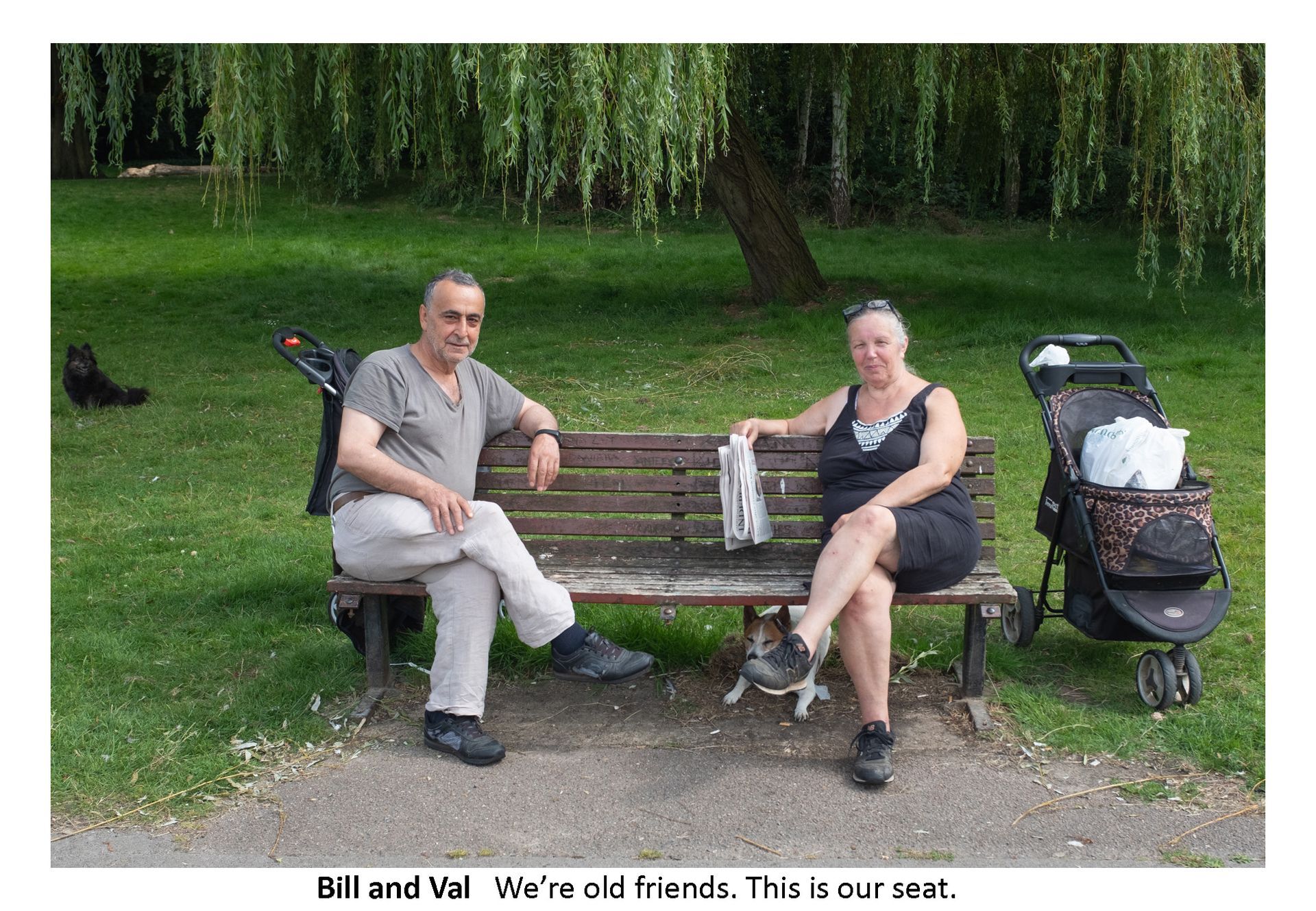 A man and a woman are sitting on a park bench.